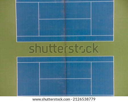 View from above. Two tennis courts. Abstraction. Minimalism. There are no people in the photo. Sports, tennis, competitions, outdoor activities, tournament, healthy lifestyle.