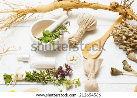 traditional alternative therapy equipments on white wooden table