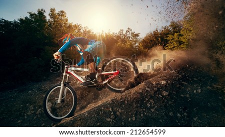 Downhill mountain bike. Young man cyclist to riding a bicycle. Royalty-Free Stock Photo #212654599