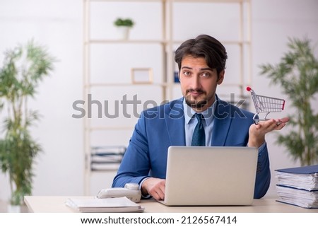 Young male employee in e-commerce concept Royalty-Free Stock Photo #2126567414