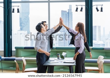 Team of young Asian entrepreneurs and startup have business meeting and encouraging each other for good energy to accomplish successful marketing plan Royalty-Free Stock Photo #2126567945