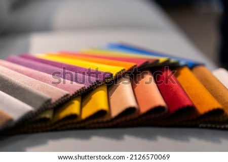 Tissue catalog. Catalog of multi-colored fabric samples. Textile industry background. Colored cotton fabric. Tissue catalog. Selects the color of the sofa. Textile industry background. Palet Royalty-Free Stock Photo #2126570069
