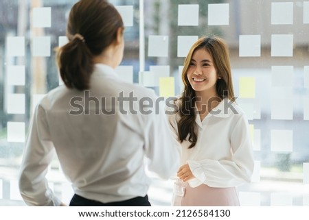 Smiling hr manager shaking hand of successful candidate after interview, Asian woman getting job, diverse business partners handshake, making great deal, agreement, employer greeting new employee.