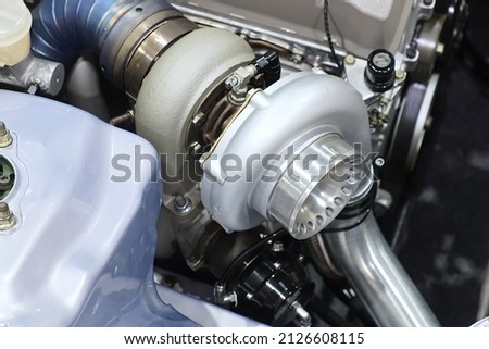 Close-up turbo engine on car bonnet for modify and tune up power speed of car Royalty-Free Stock Photo #2126608115
