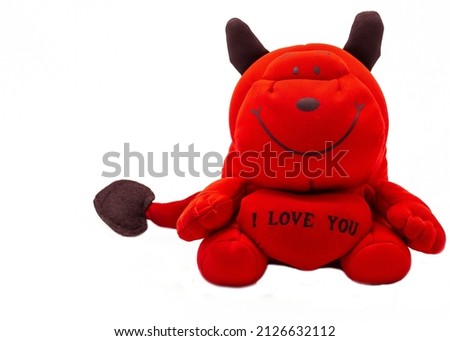A soft toy. A cheerful red behemoth with the inscription on