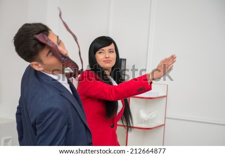 Portrait of young crying  business woman in red jacket  giving a slap in the face to her flirting colleague in office, relationship at work concept Royalty-Free Stock Photo #212664877