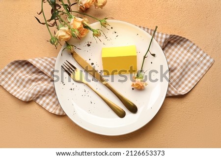 Stylish table setting with blank card and roses on color background