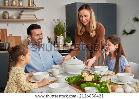 Caucasian family about to start an easter dinner at home Royalty-Free Stock Photo #2126656421
