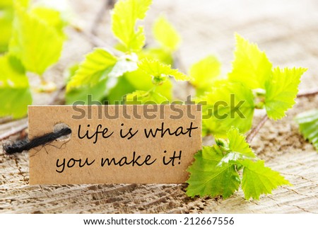 A Natural Looking Label with Green Leaves and the Saying Life Is What You Make It on it