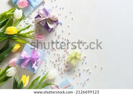 Composition with gift boxes and flowers for International Women's Day celebration on white background