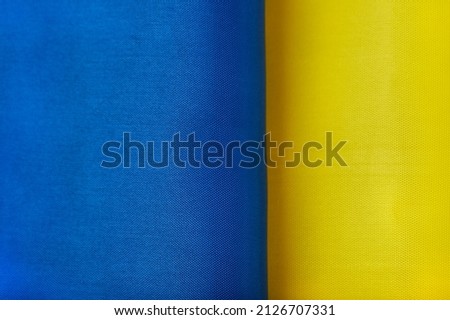 Ukrainian national flag. Blue and yellow colors fabric. Close up shot, selective focus, background, top shot