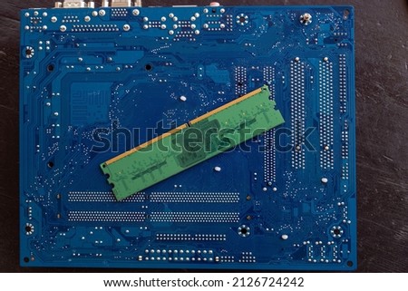 Photo of a personal computer motherboard from the back, blue