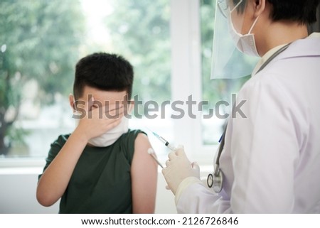 Scared child giving a vaccination at hospital
