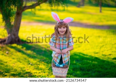 Bunny child. Kids boy hunting easter eggs. Child in bunny ears hunt Easter eggs.