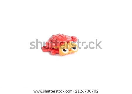 Red crab toy made of plastic on an isolated white background, can be used as a medium to introduce marine animals to children