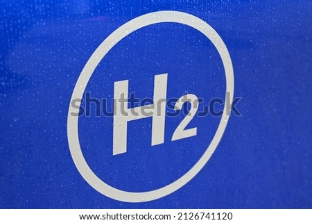 hydrogen logo on the car and gas station fuel dispenser. h2 combustion car engine for emission free ecofriendly transport. Royalty-Free Stock Photo #2126741120