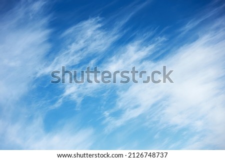 Abstract background with fast moving clouds in the blue sky