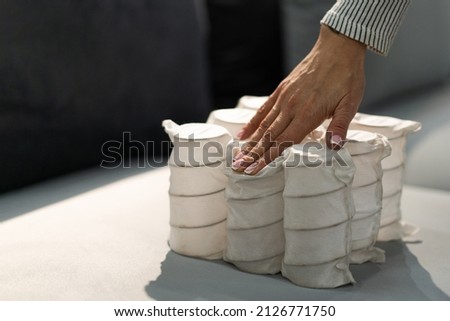 Independent spring blocks packed in spunbond. Bonding layers of springs. Furniture manufacture. Industrial and business concept. The concept of filling a mattress. Royalty-Free Stock Photo #2126771750