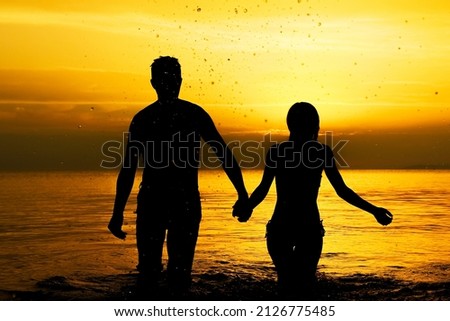 happy couple in the sea on nature travel silhouette