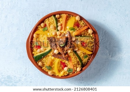 Meat and vegetable couscous, traditional Moroccan food, shot from the top, with chickpeas and cilantro Royalty-Free Stock Photo #2126808401