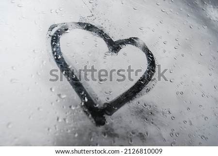 A beautiful closeup view of a heart shape on snow gray surface