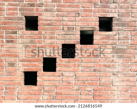 Panoramic view of empty, old, red brick wall, and holes with grey cement background with copy space