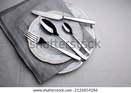 Elegance empty plate, grey napkin, cutlery set Royalty-Free Stock Photo #2126854286
