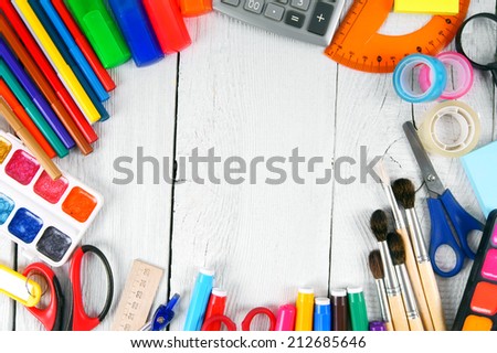 School tools. On a white, wooden background.