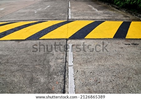 Closeup of Yellow and black xylophones on the road to slow down the speed of the car, Concept to prevent accidents on the road.