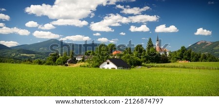 Mountain landscape with a small village church as marvelous view with blue sky, Malenovice, Moravian-Silesian Beskydy. Czech Republic. Royalty-Free Stock Photo #2126874797