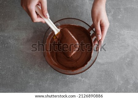 woman preparing chocolate mousse close-up top view Royalty-Free Stock Photo #2126890886