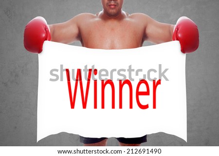 fight and competition sign with an red boxing glove holding a white banner and word winner a business symbol of competitive sales or boxing specials day  