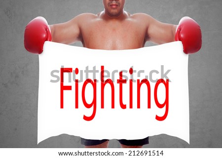 fight and competition sign with an red boxing glove holding a white banner and word fighting a business symbol of competitive sales or boxing specials day  