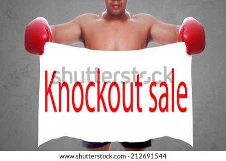 fight and competition sign with an red boxing glove holding a white banner and word knockout sale a business symbol of competitive sales or boxing specials day  