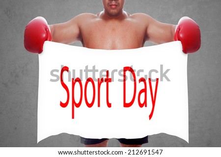 fight and competition sign with an red boxing glove holding a white banner and word sport day a business symbol of competitive sales or boxing specials day  