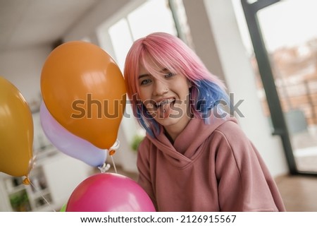 Cute young girl with colored hair looking happy