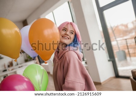 Cute young girl with colored hair looking happy