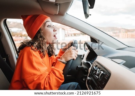 A novice girl parks a car during an exam or a driving lesson. A small accident and a bumper scratch concept Royalty-Free Stock Photo #2126921675