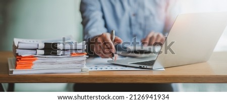Business Documents, Auditor businesswoman checking searching document legal prepare paperwork or report for analysis TAX time,accountant Documents data contract partner deal in workplace office Royalty-Free Stock Photo #2126941934