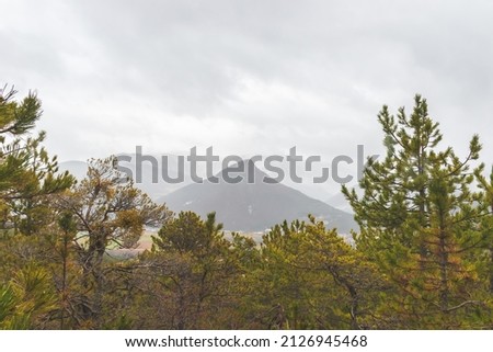 A picturesque landscape view of the French Alps mountains during the rain on a cold winter day (Veynes, Chateavieux)
