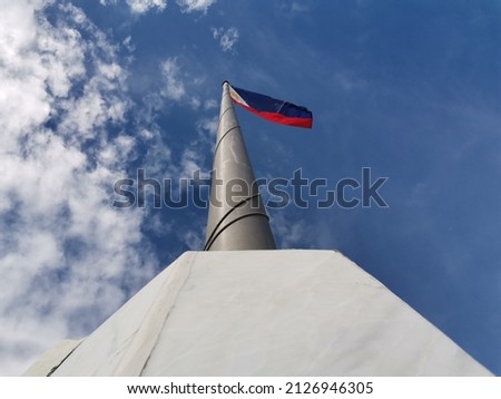 A vertical low angle view of the Philippine flag against the sky