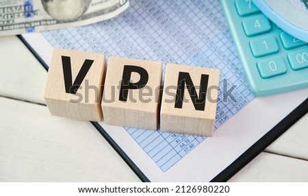 a wooden blocks with the letters VPN written on it on a white background. VPN - short for Virtual Private Network