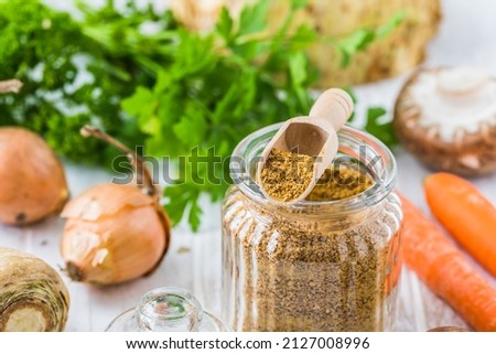 Homemade vegetable broth powder, organic vegetable stock, with raw vegetables on white wooden background, close up