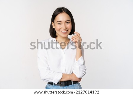 Young asian woman, professional entrepreneur standing in office clothing, smiling and looking confident, white background Royalty-Free Stock Photo #2127014192