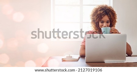 We never fail to be inspired and motivated by technology. Cropped shot of a young female designer having coffee while working on her laptop against a digitally enhanced background.