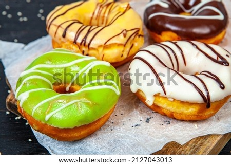 Glazed donut on wood background.