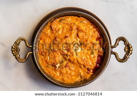 Traditional turkish menemen with eggs, sausage sucuk and tomatoes. White background. Top view Royalty-Free Stock Photo #2127046814