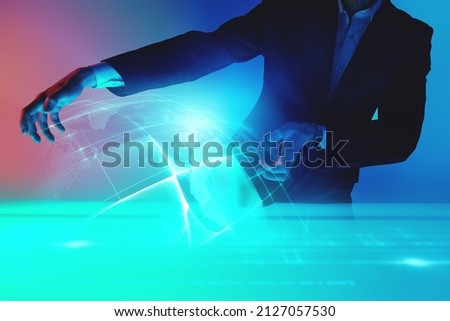 Digital holograms, charts. A  business specialist demonstrates a hologram of global business processes using virtual technologies. Contemporary digital business technologies.  Royalty-Free Stock Photo #2127057530
