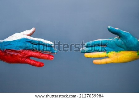 Flags of Ukraine and Russia The flag on the hands move away from each other. Conflict Ukraine vs Russia in World War Crisis Concept Royalty-Free Stock Photo #2127059984