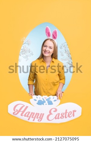 Smiling female in ear headband wishing you happy Easter while standing behind egg shaped frame surrounded by yellow copyspace